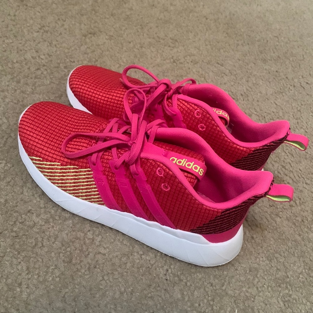 Red , and pink adidas girls ( or boys ) gym shoes